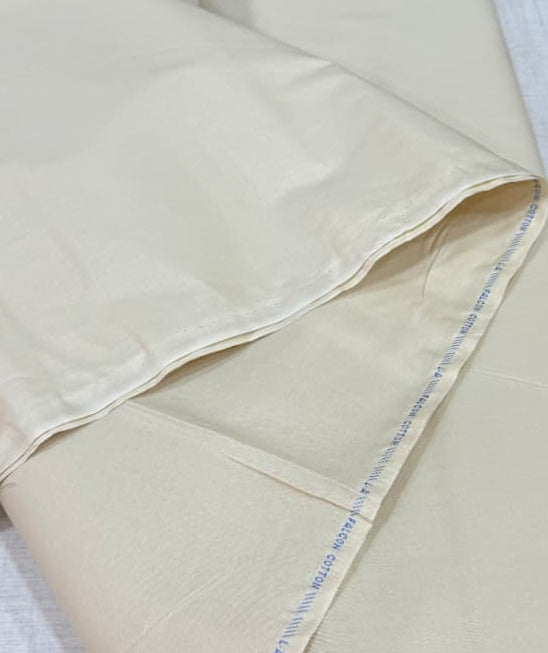 Beige fabric with visible stitching on a white surface